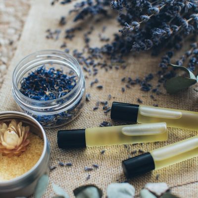 Aromatherapy still life showcasing lavender sprigs, bath salts, and massage oil bottles.